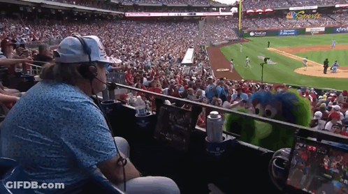 Man With Headphones Watching Baseball Game In Stadium GIF