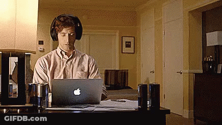 Man With Headphones Working On Apple Laptop GIF