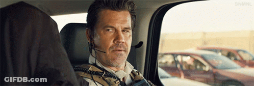 Man With Headset In Back Seat Looking Out Window GIF