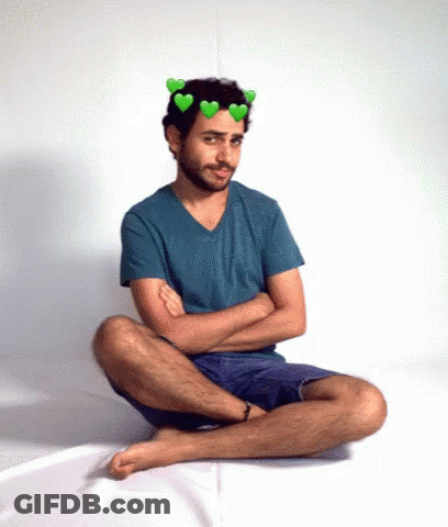 Man With Hearts On Head Sitting On Floor GIF