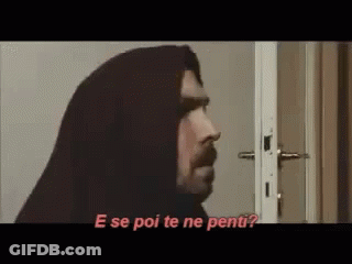 Man With Hood Standing In Front Of Door Talking GIF