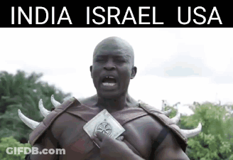 Man With Horns On Shoulders In Front Of Trees With India Israel USA Above GIF