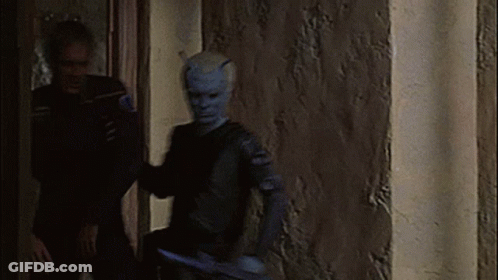 Man With Horns Standing Next To Woman GIF