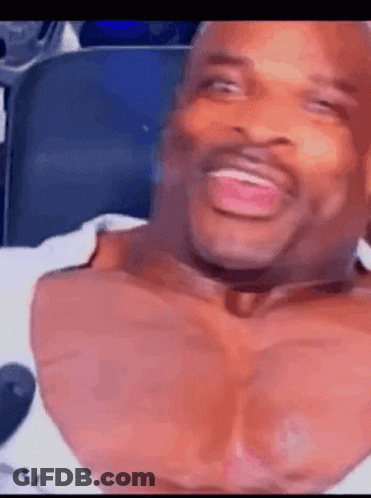 Man With Huge Chest Laughing In Chair GIF