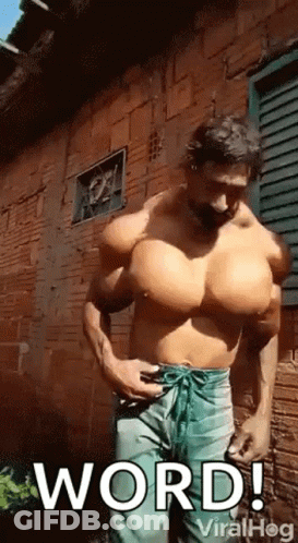 Man With Huge Muscles In Front Of Brick Building GIF
