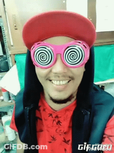 Man With Hypnotic Glasses And Red Hat Smiling GIF