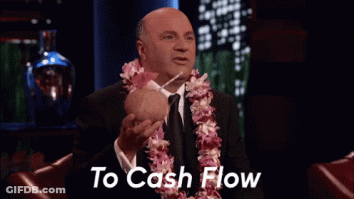 Man With Lei Holding Coconut And Straw Saying To Cash Flow GIF