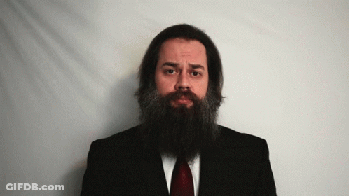 Man With Long Beard In Black Suit And Red Tie GIF