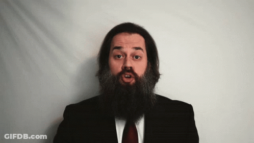 Man With Long Beard In Black Suit And Red Tie GIF