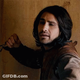 Man With Long Black Hair And Beard Holding Scissors GIF