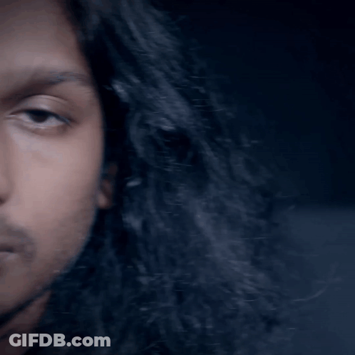 Man With Long Black Hair And Beard Looking At Camera GIF