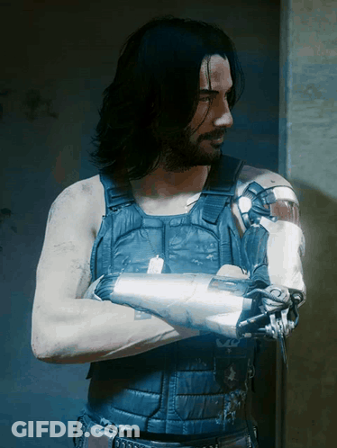 Man With Long Black Hair Beard Blue Vest Robotic Arm GIF