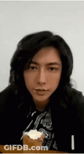 Man With Long Black Hair Eating Cake GIF
