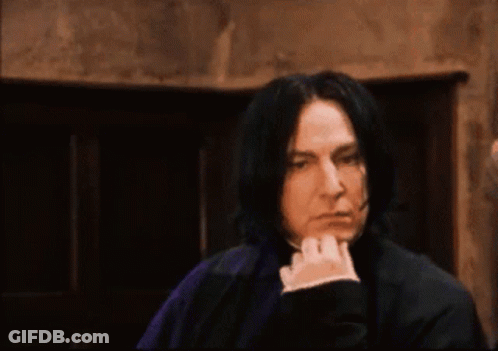 Man With Long Black Hair Hand On Chin Dark Room GIF