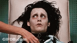 Man With Long Black Hair Lying On Bed With Woman's Hand On Chest GIF
