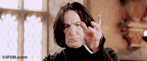 Man With Long Black Hair Making Funny Face Holding Wand GIF