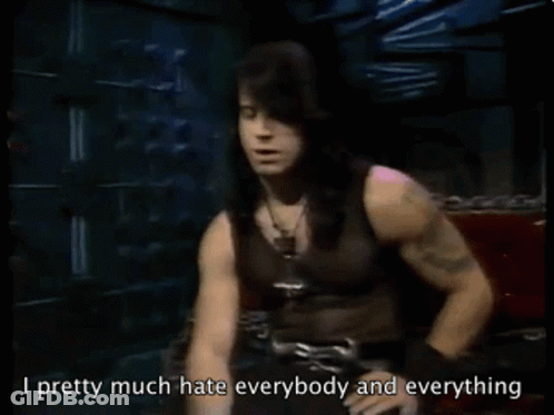 Man With Long Black Hair Sitting On Red Couch Says I Pretty Much Hate Everybody And Everything GIF