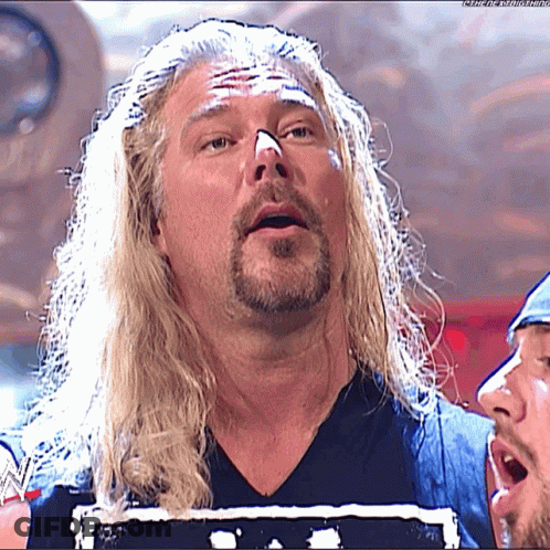 Man With Long Blonde Hair And Beard In WWE Shirt GIF