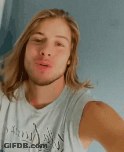 Man With Long Blonde Hair And Beard Smiling In Inspired Tank Top GIF
