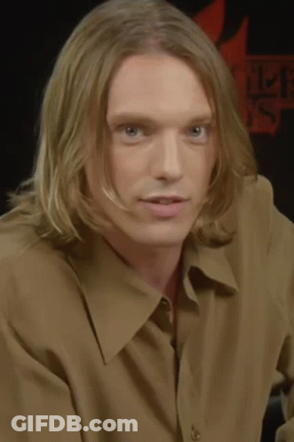 Man With Long Blonde Hair In Brown Shirt GIF