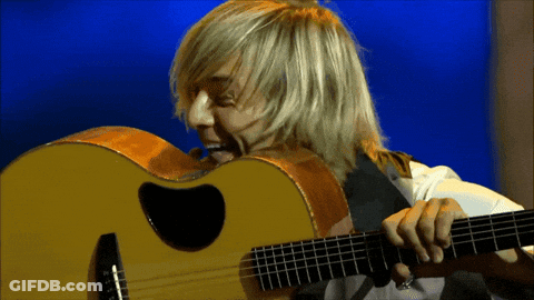 Man With Long Blonde Hair Playing Guitar GIF