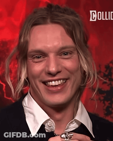 Man With Long Blonde Hair Smiling On Red Background Saying Collid GIF