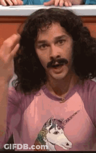Man With Long Curly Hair And Mustache In Pink Unicorn Shirt GIF