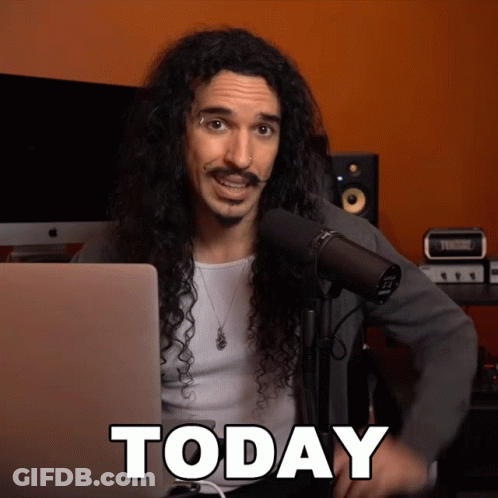 Man With Long Curly Hair At Microphone GIF