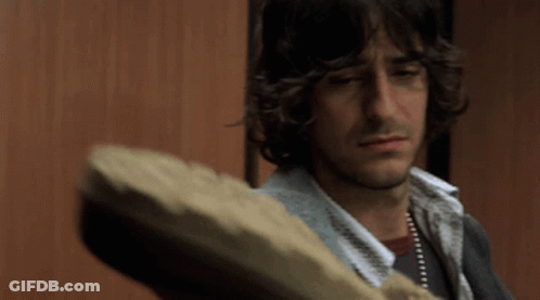Man With Long Curly Hair Holding Bread GIF