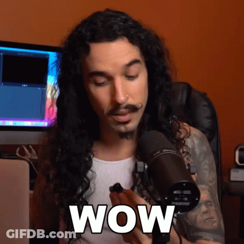 Man With Long Curly Hair Holding Microphone Saying Wow GIF