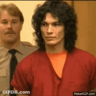 Man With Long Curly Hair In Red Robe And Orange Shirt GIF