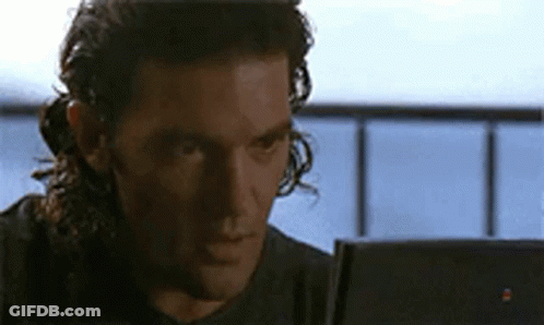 Man With Long Curly Hair Looking At Laptop Computer GIF