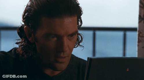 Man With Long Curly Hair Looking At Laptop GIF