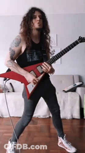 Man With Long Curly Hair Playing Guitar GIF
