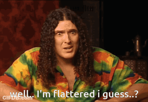 Man With Long Curly Hair Saying Well I'm Flattered GIF