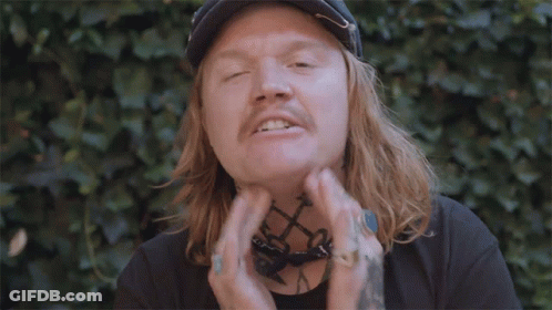 Man With Long Hair And Bandana Giving Peace Sign GIF