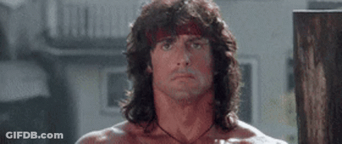 Man With Long Hair And Bandana Standing In Room GIF