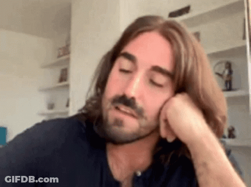 Man With Long Hair And Beard Hand On Chin GIF
