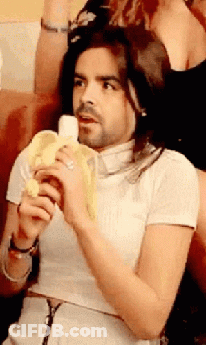 Man With Long Hair And Beard Holding Banana GIF