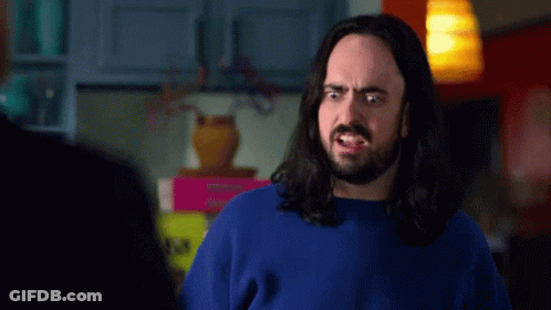 Man With Long Hair And Beard In Blue Sweater Making Funny Face GIF