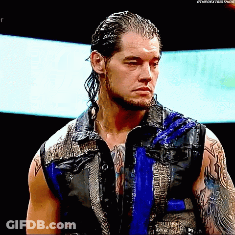 Man With Long Hair And Beard In Blue Vest And Black Shirt GIF
