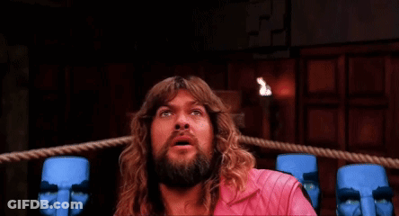 Man With Long Hair And Beard In Boxing Ring Surrounded By Blue Statues GIF