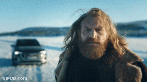 Man With Long Hair And Beard In Front Of Car GIF