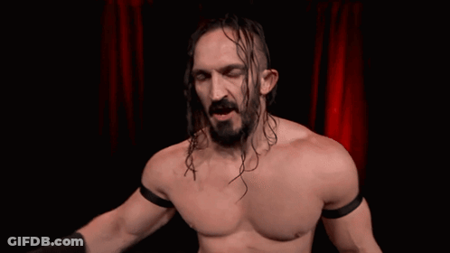 Man With Long Hair And Beard In Front Of Red Curtain Treated Like A Bum GIF