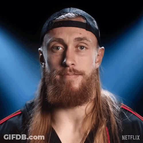 Man With Long Hair And Beard In Netflix Hat And Shirt GIF