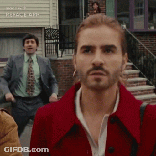 Man With Long Hair And Beard In Red Coat And Tie GIF