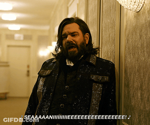 Man With Long Hair And Beard In Sequined Jacket GIF