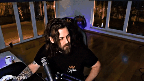 Man With Long Hair And Beard In Shirt Saying Calm GIF
