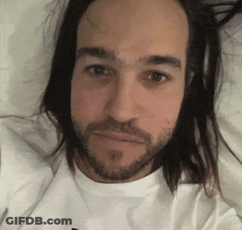 Man With Long Hair And Beard Laying Down GIF