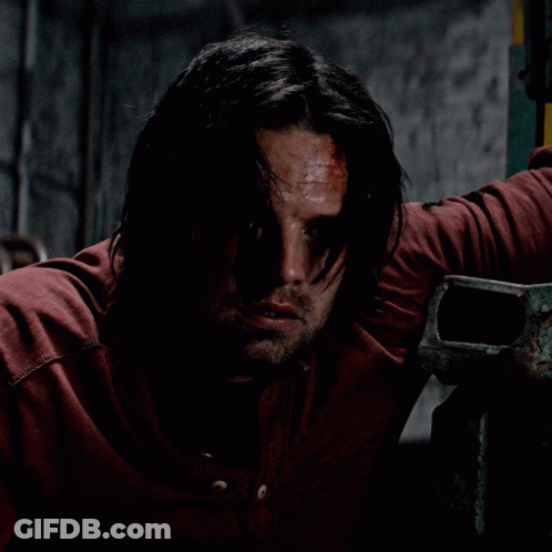Man With Long Hair And Beard Leaning Against Wall GIF